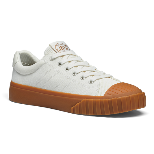 White sneaker with gum sole on a white background