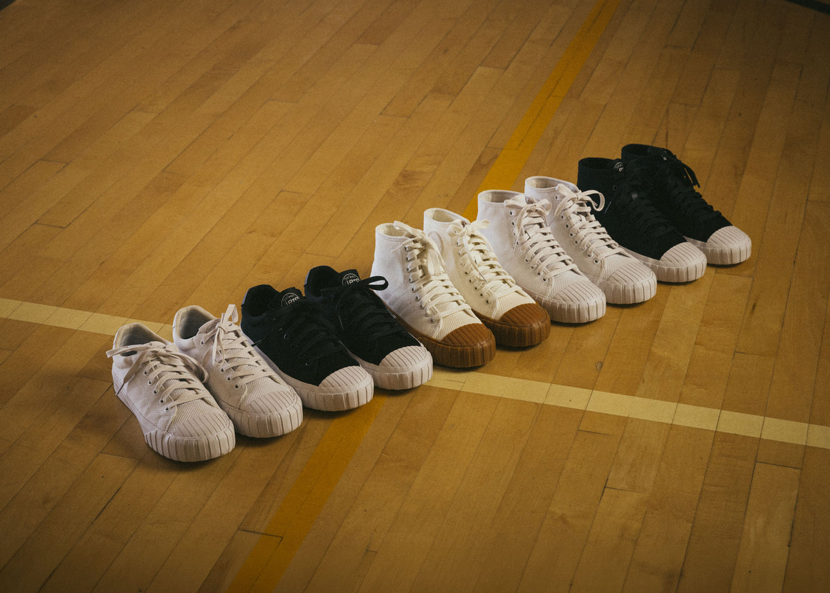 Five pairs of Red Ball Jets' sneakers lined up on a basketball court.