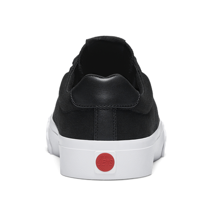 Black sneaker with a white sole and red circular Red Ball Jets logo on a white background