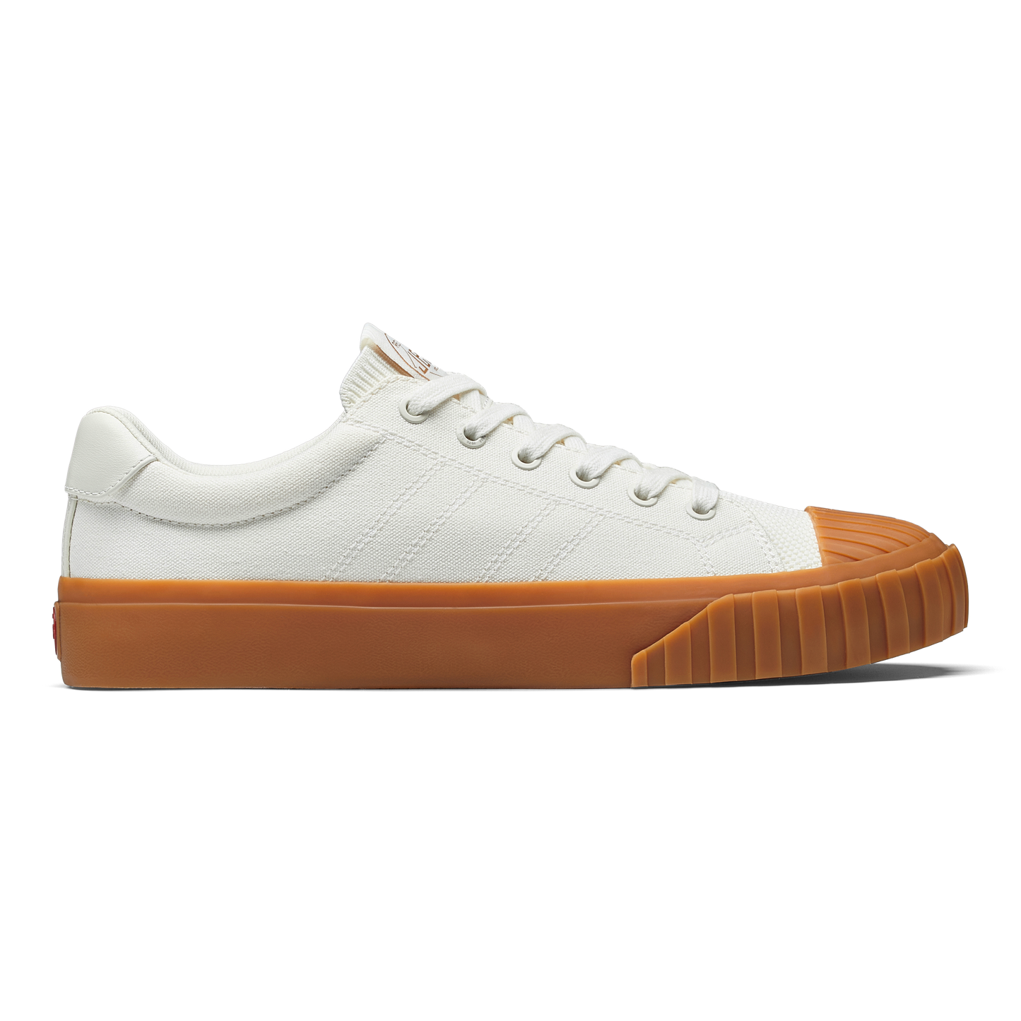 White sneaker with gum sole on a white background