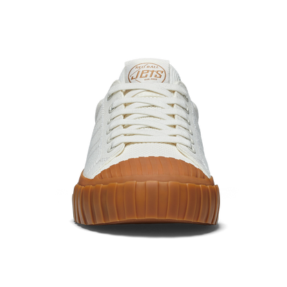 White sneaker with gum sole on a white background