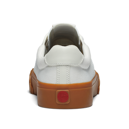 White sneaker with gum sole on a white background