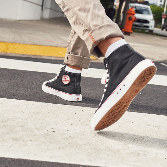 a person walking wearing the black and red 51 hi